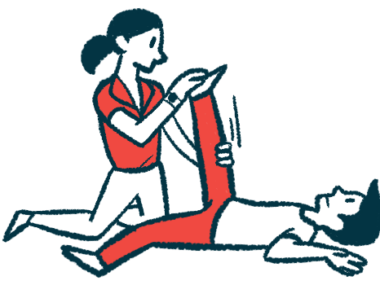 A physical therapist moves a patient's leg.